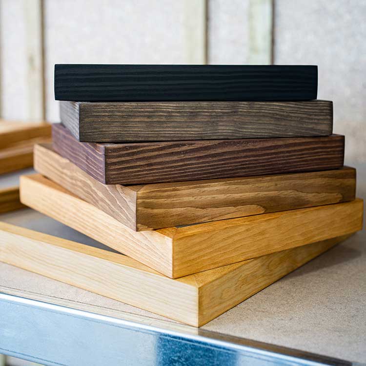 Stack of wooden frames with different colors finishes