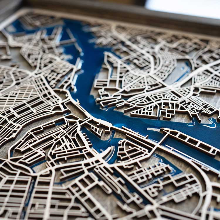 Close-up of a detailed city map model with blue waterways.