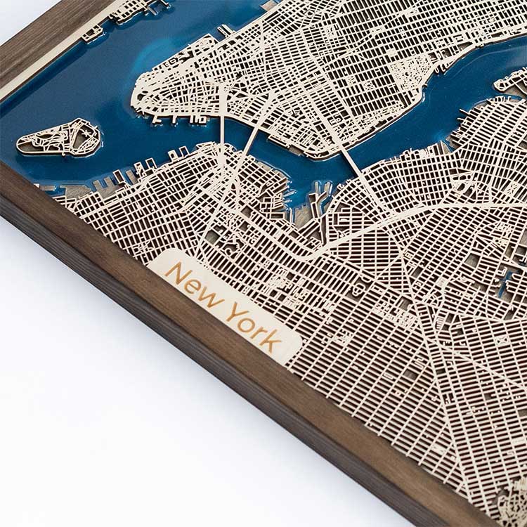 Wooden model of New York city layout with waterways and streets, branded 'New York'.