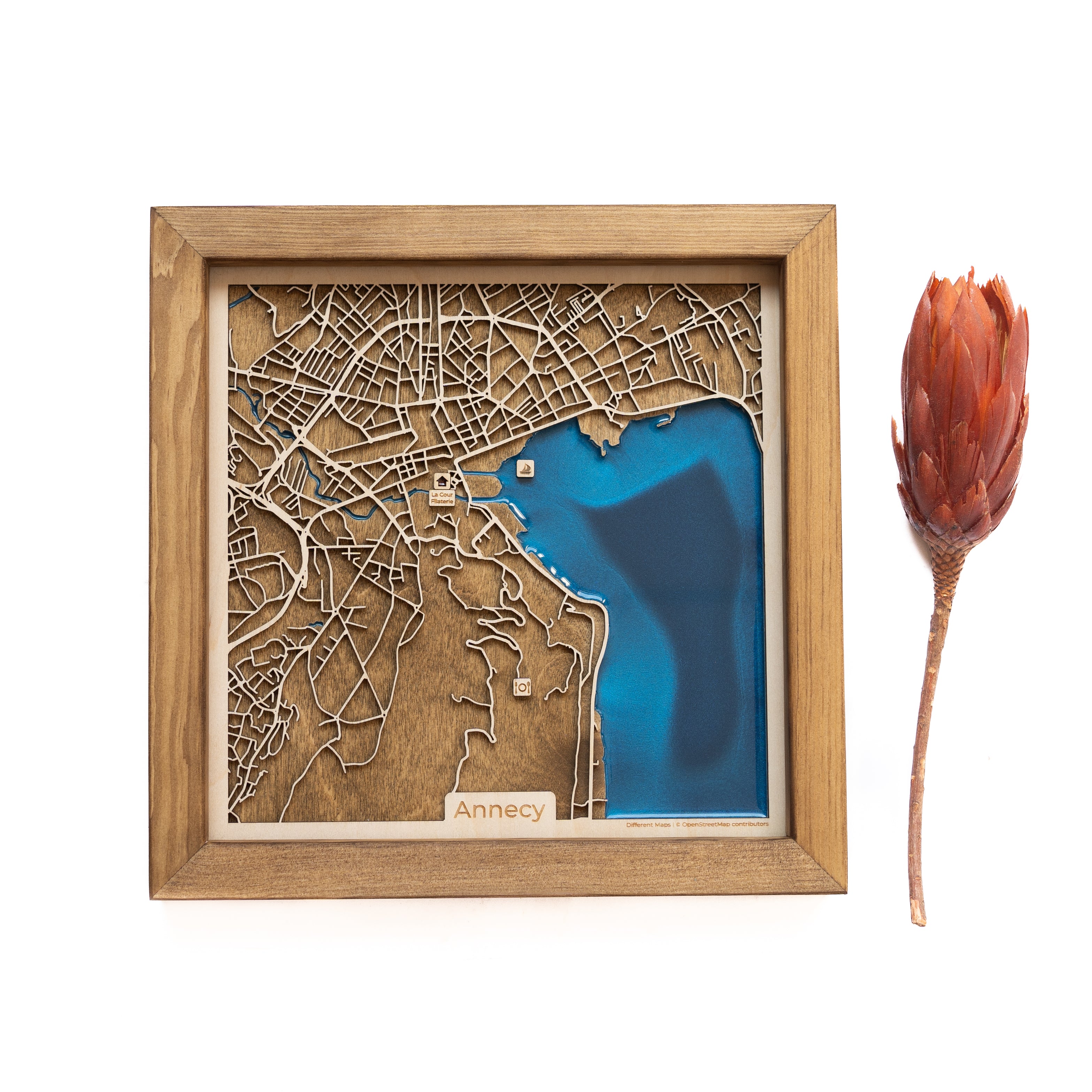 Capture the essence of Annecy with our custom wooden map. Crafted with precision, this unique piece intricately showcases the beauty of this charming French town.